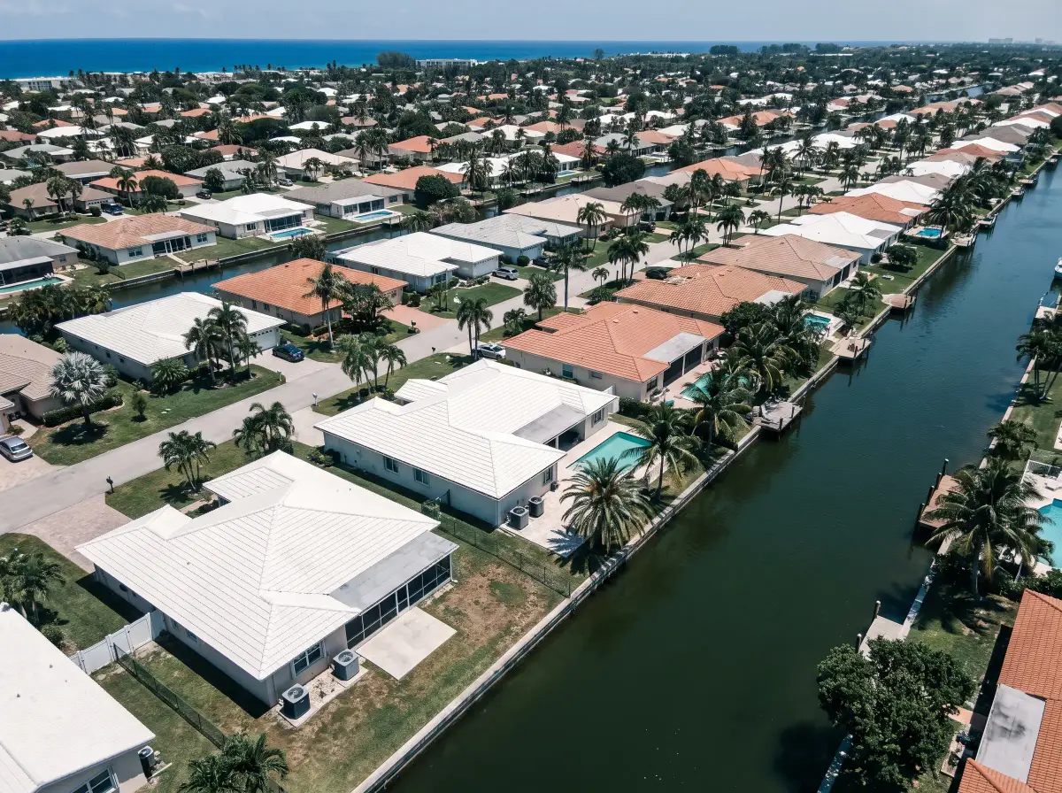 Aerial view of a north Broward neighborhood of tile-roofed homes along canals