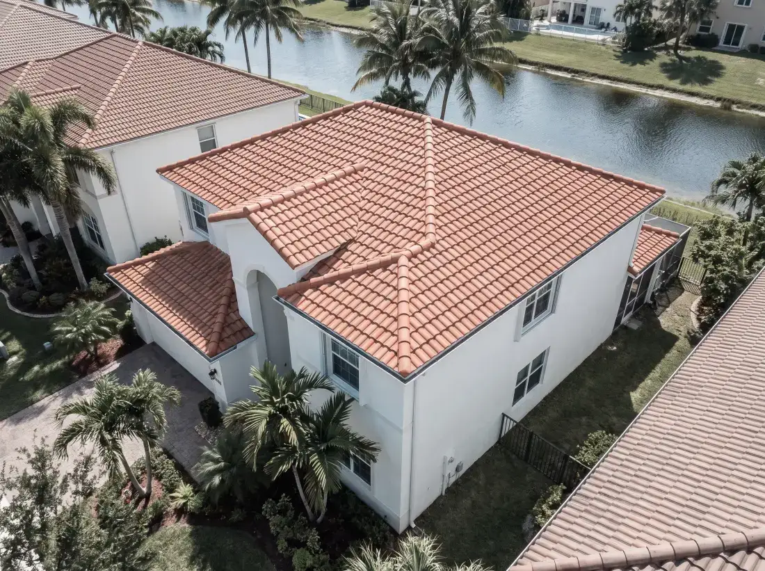 Aerial view of a two-storey home with a new terracotta barrel tile roof
